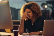 Women working at screen looking stressed 