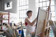 Lady painting on large canvas