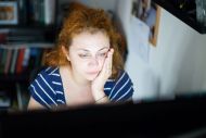 Women working at screen looking tired