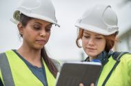 Two female workers in hi vis and hard hats