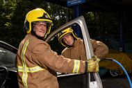 Two firefighters removing car door