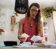 Woman looking at bills