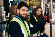 Male and female workers in hi vis jackets and a scarf