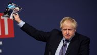 Boris Johnson holds up the 2019 Conservative manifesto