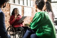 Business woman in wheelchair leading a discussion