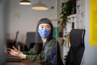 Woman wearing a face mask at an office.