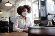 Woman wearing a face mask at an office.
