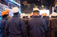 Industrial workers turn their backs