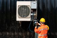 Man in high vis jacket next to ventilation unit