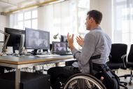 man in wheelchair on a zoom call at work