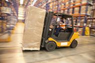Man reverses forklift truck in a warehouse