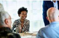 Candid portrait of mid adult black businesswoman smiling in meeting