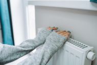 person warming hands on radiator