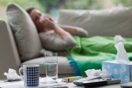 sick woman laying on sofa
