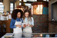 Young waitresses look at a tablet