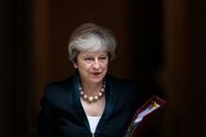 British Prime Minister Theresa May walking out of 10 Downing Street holding a folder