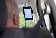 A driver looks at a mounted smartphone app screen