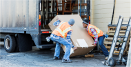 Two workers loading truck