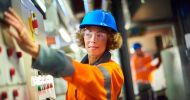 Woman in hard hat and high vis overalls