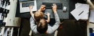 working mum at desk with child on lap