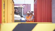 Workers at container port. Photo: Monty Rakusen