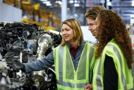Colleagues talking in a car factory