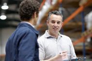 two male workers talking to each other