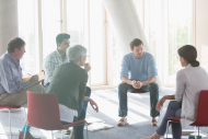 Some people sitting in a circle chatting