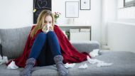 a sick woman sitting on a sofa