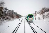 A train travelling through the snow on a winter's day