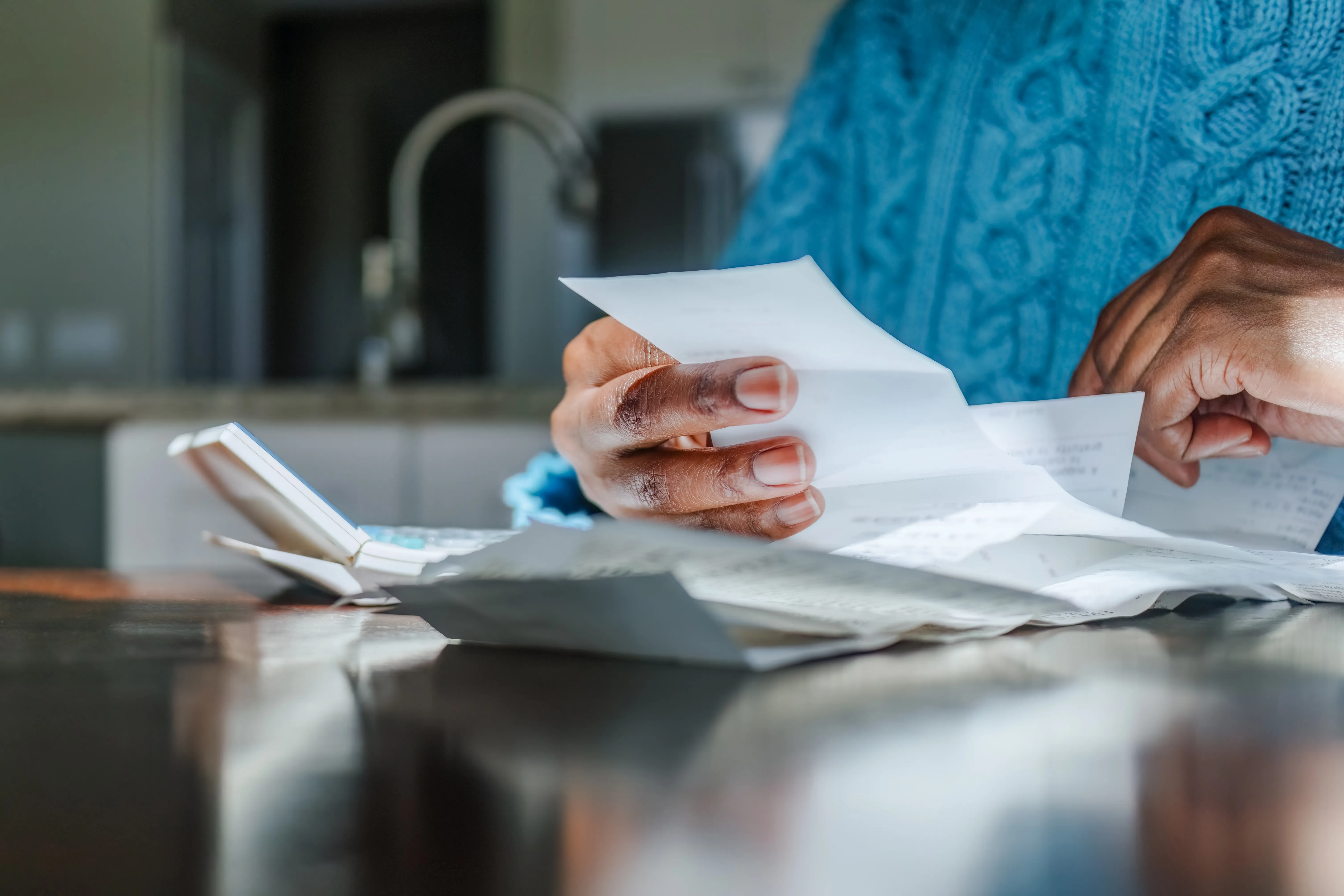 person looking at bills