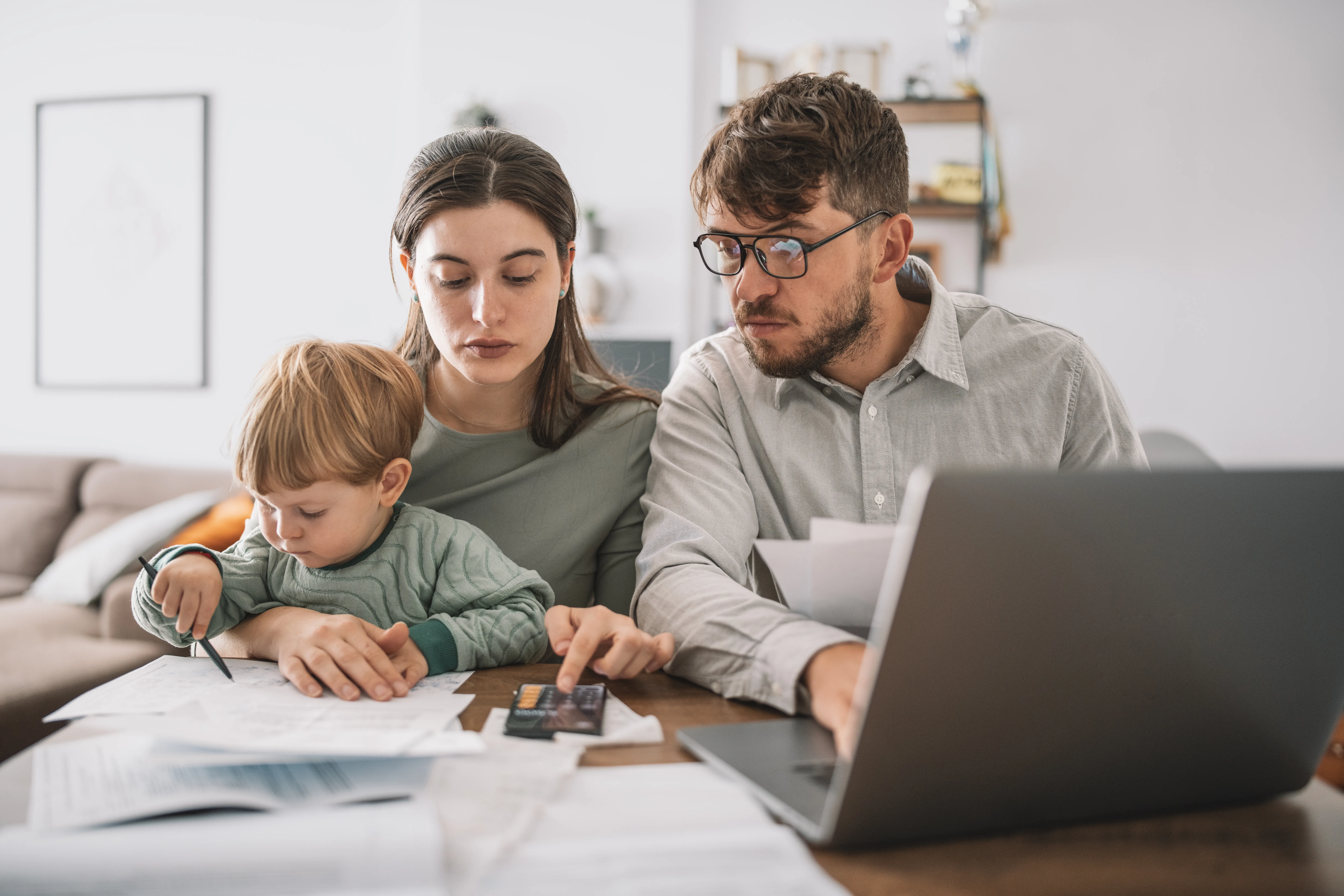 young family looking at bills